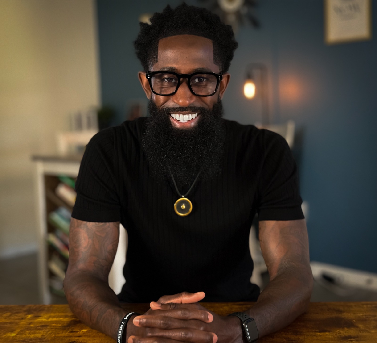 Charles Jackson II seated at a wood table, smiling