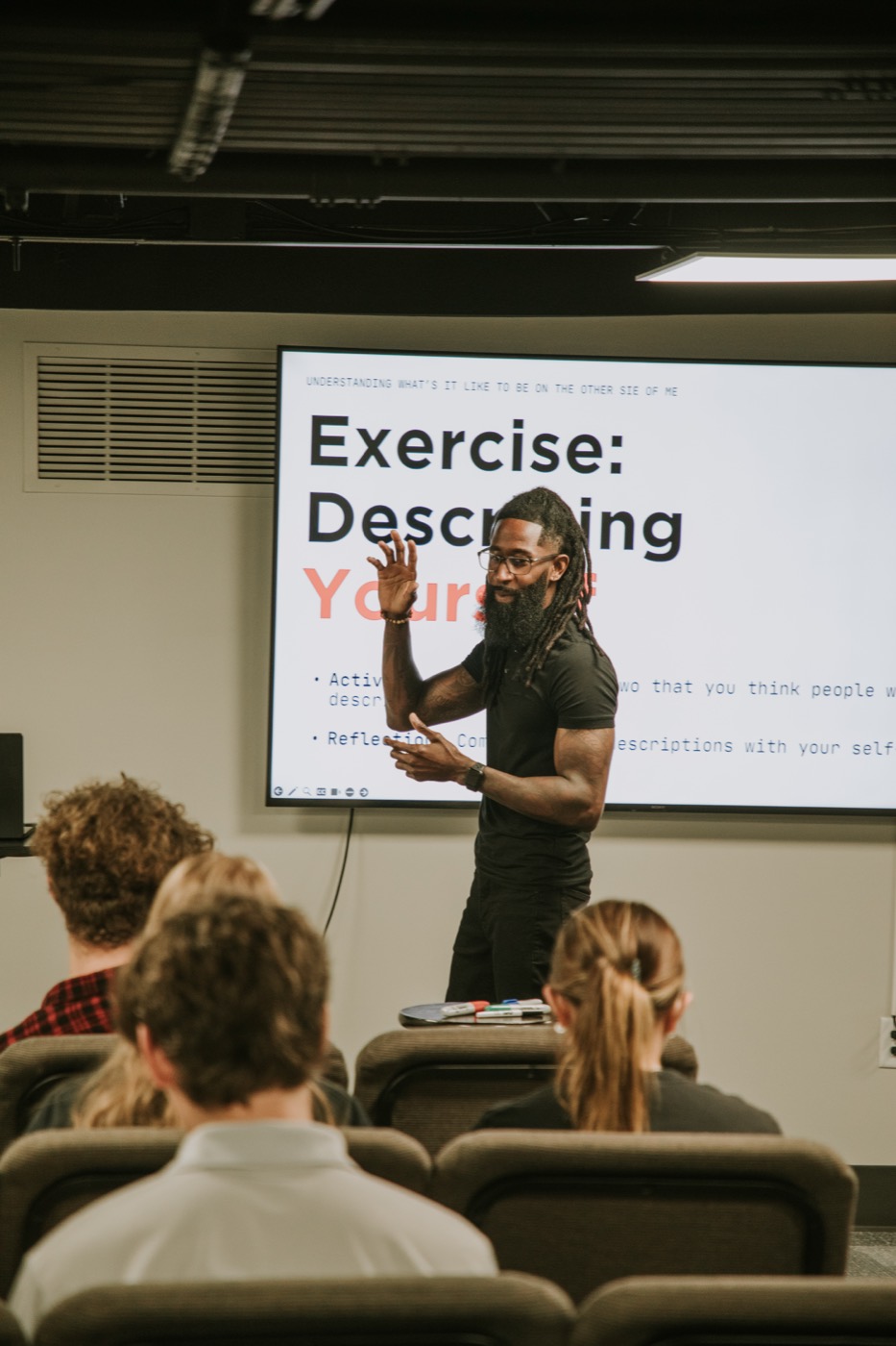 Charles teaching a classroom of university students